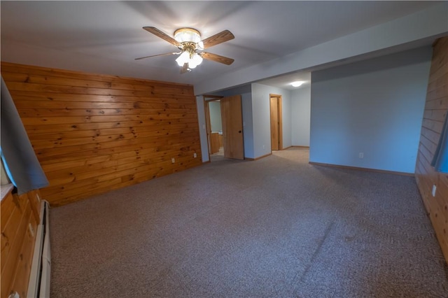 817 Flax Island Rd, Otego, NY 13825 - spare room featuring wood walls, light colored carpet, a ceiling fan, and a baseboard heating unit