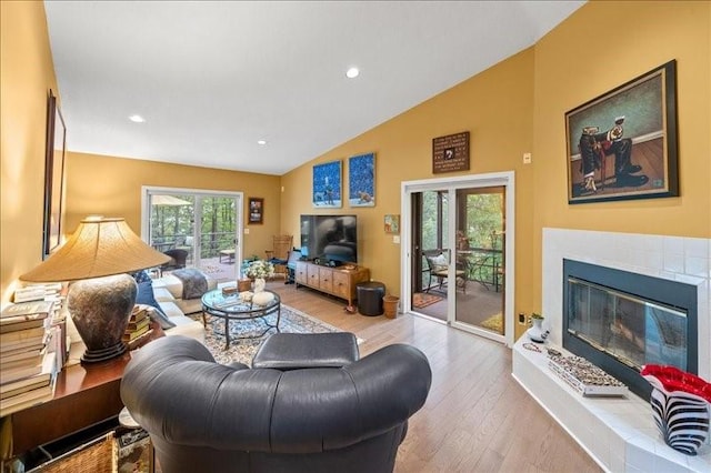 823 Skylane, Union, NY 13760 - living area featuring wood finished floors, a glass covered fireplace, high vaulted ceiling, and recessed lighting