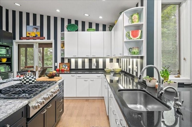 823 Skylane, Union, NY 13760 - kitchen featuring open shelves, stainless steel gas stovetop, light wood-style flooring, white cabinets, and dark stone countertops
