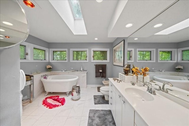 823 Skylane, Union, NY 13760 - bathroom with a skylight, a freestanding bath, recessed lighting, and vanity