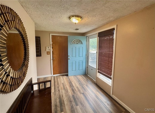 210 Wynnfield Dr, Camillus, NY 13219 - entryway featuring wood finished floors and a textured ceiling
