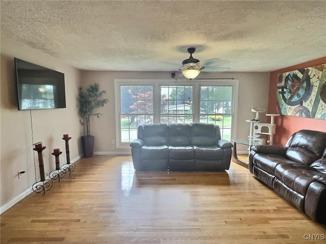 210 Wynnfield Dr, Camillus, NY 13219 - living area featuring wood finished floors, healthy amount of natural light, a textured ceiling, and ceiling fan