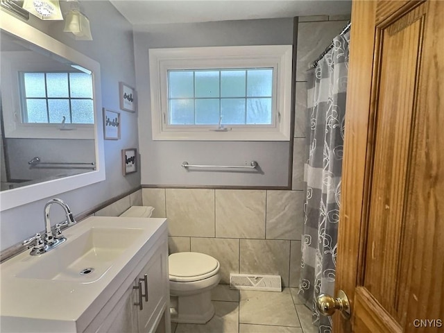 210 Wynnfield Dr, Camillus, NY 13219 - full bath with tile walls, vanity, tile patterned floors, wainscoting, and a shower with shower curtain