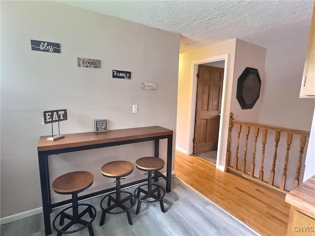 210 Wynnfield Dr, Camillus, NY 13219 - dining room featuring wood finished floors and a textured ceiling