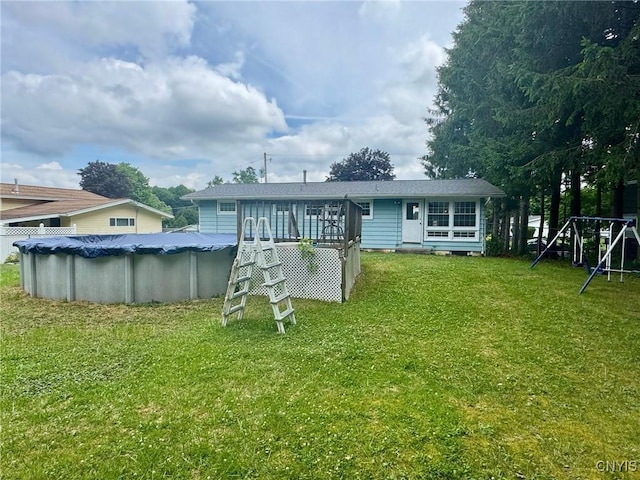 210 Wynnfield Dr, Camillus, NY 13219 - rear view of house featuring a covered pool, a deck, and a lawn