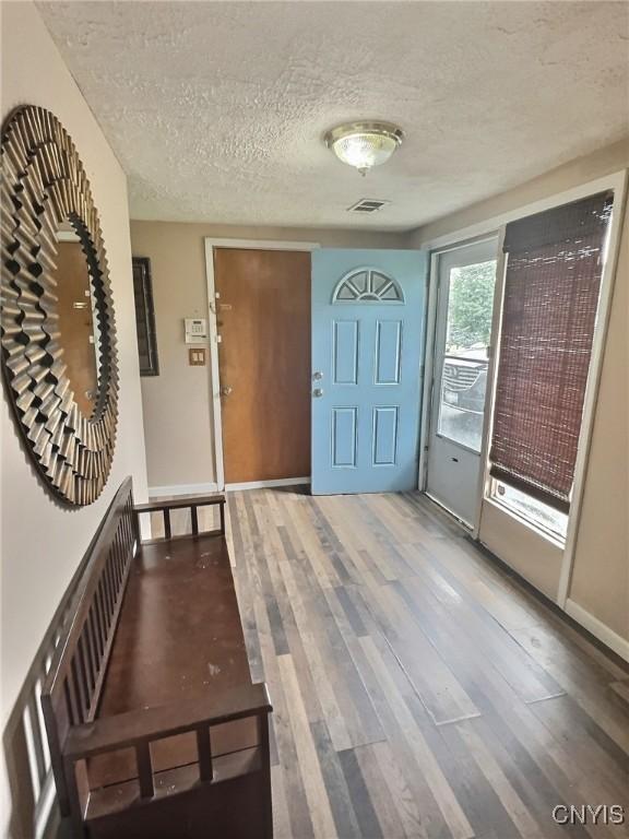 210 Wynnfield Dr, Camillus, NY 13219 - foyer featuring a textured ceiling and wood finished floors