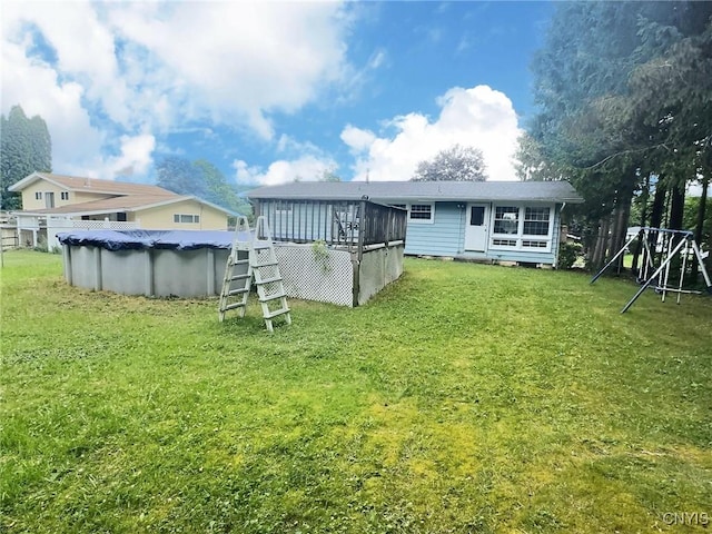 210 Wynnfield Dr, Camillus, NY 13219 - rear view of house with a covered pool, a wooden deck, and a yard