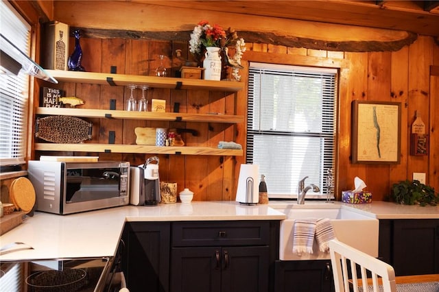 5681 Leidenfrost Adams Rd, Hector, NY 14841 - kitchen with stainless steel microwave, wooden walls, healthy amount of natural light, and light countertops