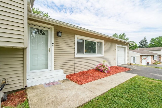 209 Thompson Rd, Henrietta, NY 14623 - doorway to property with asphalt driveway and an attached garage