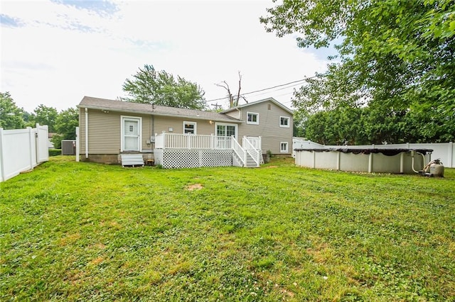 209 Thompson Rd, Henrietta, NY 14623 - rear view of house with a deck and a covered pool