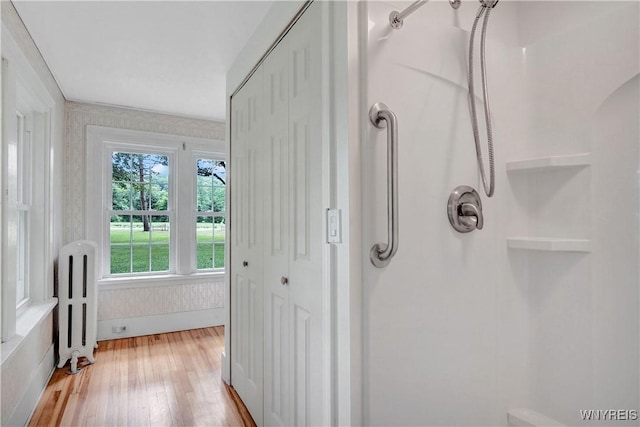 7709 Olean Rd, Holland, NY 14080 - bathroom with hardwood / wood-style floors, radiator, and a shower