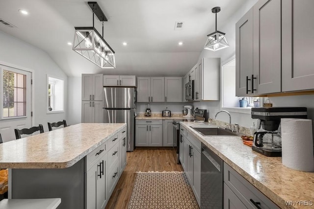 9184 Newcomb Rd, Evans, NY 14006 - kitchen featuring appliances with stainless steel finishes, vaulted ceiling, light countertops, light wood-style floors, and gray cabinetry