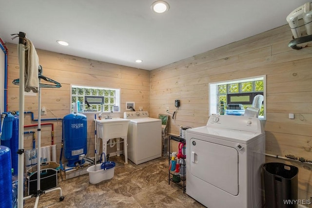 9184 Newcomb Rd, Evans, NY 14006 - laundry room with wooden walls, washing machine and dryer, plenty of natural light, and recessed lighting