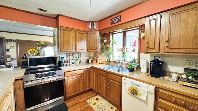 1155 County Route 53, Scriba, NY 13126 - kitchen with appliances with stainless steel finishes, light countertops, plenty of natural light, tasteful backsplash, and ornamental molding
