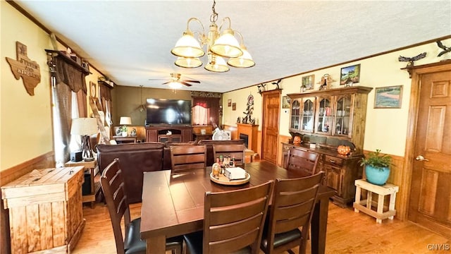 1155 County Route 53, Scriba, NY 13126 - dining space with a chandelier, light wood-style flooring, ceiling fan, a wainscoted wall, and crown molding