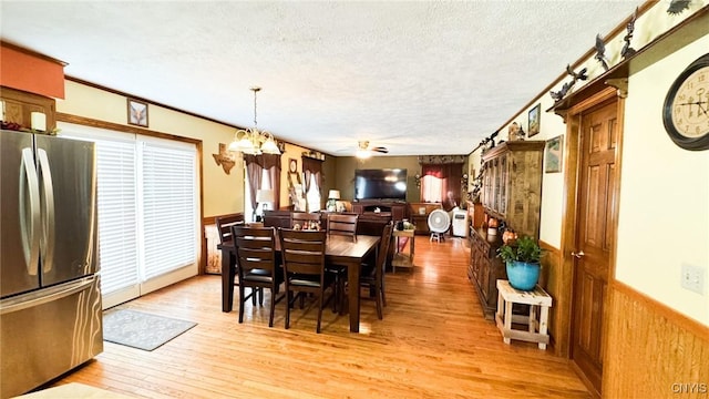 1155 County Route 53, Scriba, NY 13126 - dining room with light wood-type flooring, healthy amount of natural light, a textured ceiling, wainscoting, and a chandelier