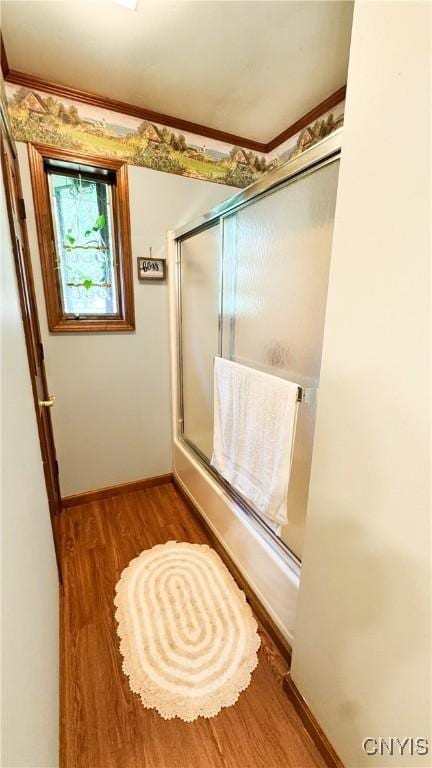 1155 County Route 53, Scriba, NY 13126 - bathroom featuring wood finished floors, crown molding, and shower / bath combination with glass door
