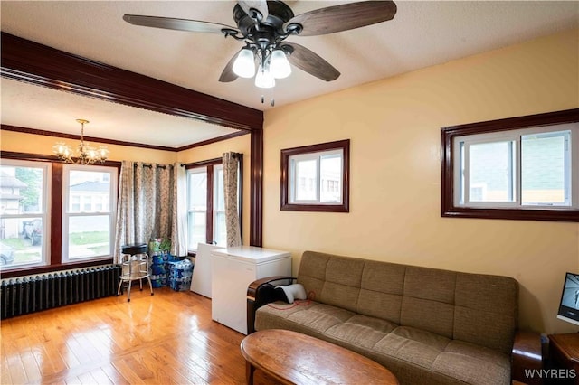 14 Phyllis Ave, Buffalo, NY 14215 - living area with radiator heating unit, a chandelier, light wood-type flooring, and a ceiling fan