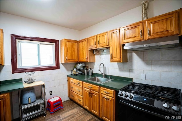 14 Phyllis Ave, Buffalo, NY 14215 - kitchen with gas range, under cabinet range hood, dark countertops, dark wood finished floors, and brown cabinets