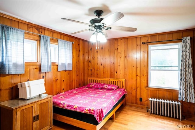 14 Phyllis Ave, Buffalo, NY 14215 - bedroom with radiator, light wood finished floors, and wooden walls