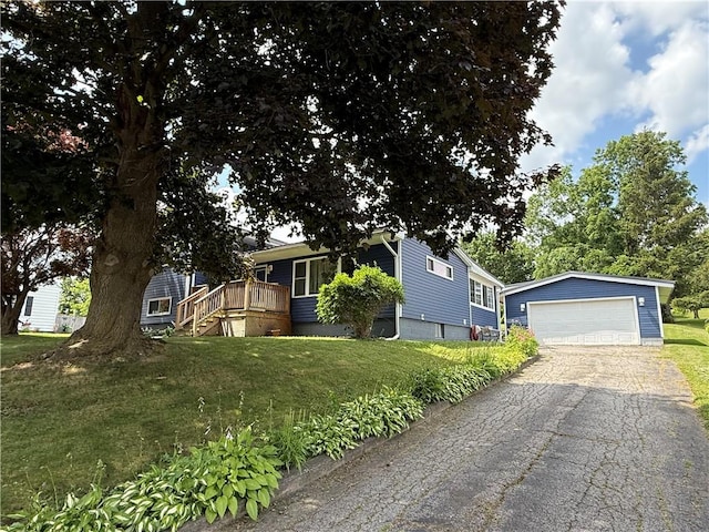 5 Breen St, Mount Morris, NY 14510 - view of front of home featuring an outbuilding, a detached garage, a front yard, and a wooden deck