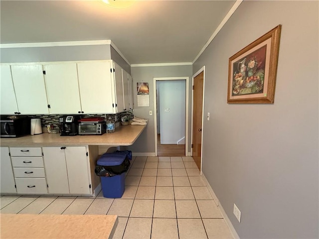 5 Breen St, Mount Morris, NY 14510 - kitchen featuring light tile patterned floors, light countertops, white cabinetry, and crown molding