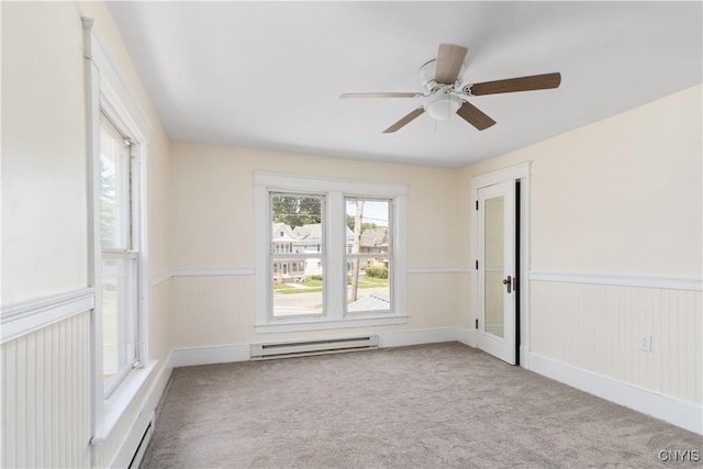 315 Otsego St, German Flatts, NY 13357 - carpeted empty room with a baseboard heating unit, a ceiling fan, and wainscoting