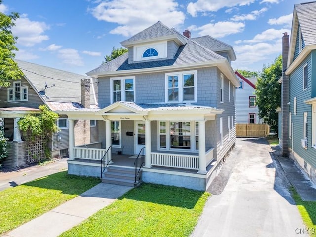 315 Otsego St, German Flatts, NY 13357 - traditional style home featuring a porch, concrete driveway, roof with shingles, and a chimney