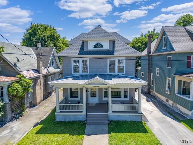 315 Otsego St, German Flatts, NY 13357 - traditional style home with covered porch, roof with shingles, a metal roof, and a front lawn