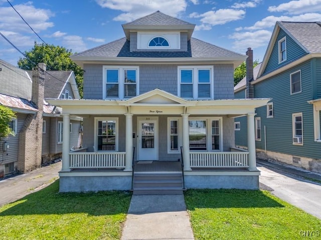 315 Otsego St, German Flatts, NY 13357 - traditional style home featuring covered porch, roof with shingles, and a front lawn