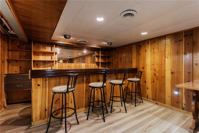 183 Castle Rd, Henrietta, NY 14623 - indoor dry bar featuring light wood finished floors and wood walls