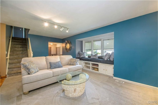 4043 Libra Ln, Clay, NY 13090 - living area featuring stairway, light colored carpet, and rail lighting