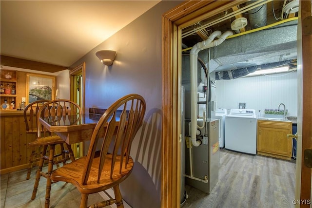 4043 Libra Ln, Clay, NY 13090 - dining area with washing machine and clothes dryer and light wood-type flooring