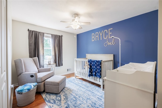 131 Cindy Ln, Greece, NY 14626 - bedroom with wood finished floors, a nursery area, and a ceiling fan