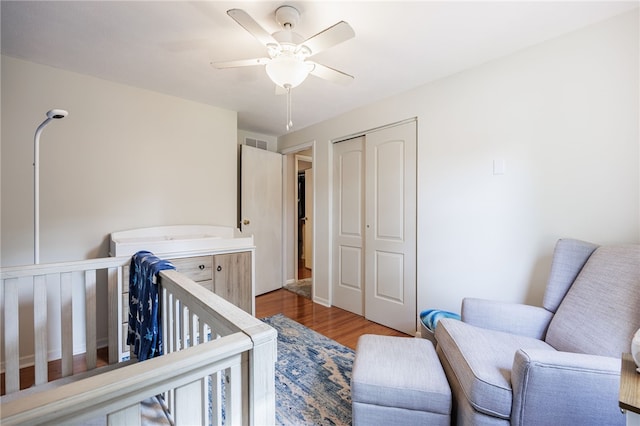 131 Cindy Ln, Greece, NY 14626 - bedroom featuring a closet, wood finished floors, ceiling fan, and a nursery area