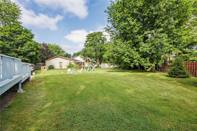 131 Cindy Ln, Greece, NY 14626 - fenced backyard with a playground and view of scattered trees
