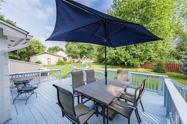 131 Cindy Ln, Greece, NY 14626 - wooden terrace with outdoor dining space, a playground, and a fenced backyard