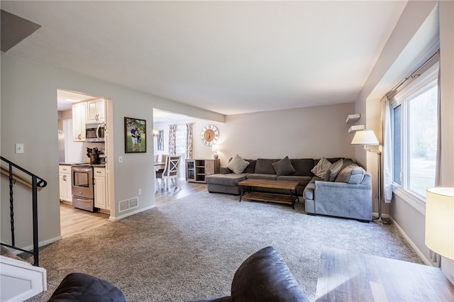 131 Cindy Ln, Greece, NY 14626 - living room with light carpet and baseboards