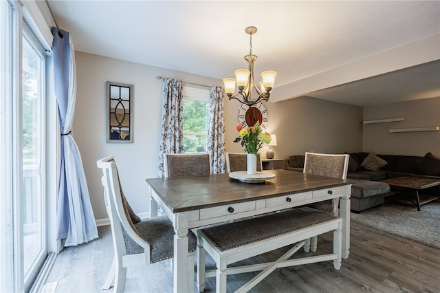 131 Cindy Ln, Greece, NY 14626 - dining space with a chandelier and wood finished floors