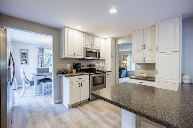 131 Cindy Ln, Greece, NY 14626 - kitchen with appliances with stainless steel finishes, dark countertops, white cabinetry, recessed lighting, and light wood-style flooring
