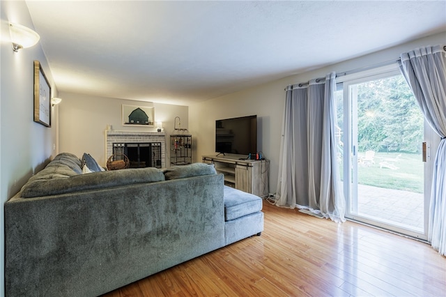 131 Cindy Ln, Greece, NY 14626 - living room featuring light wood-style flooring and a brick fireplace