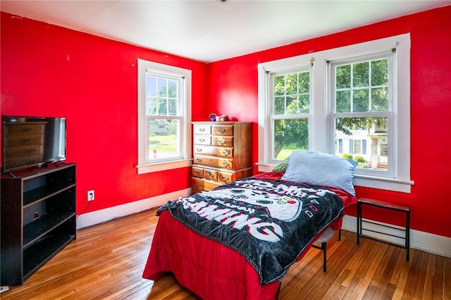 67 Pleasant St, Phelps, NY 14532 - bedroom with multiple windows and hardwood / wood-style floors