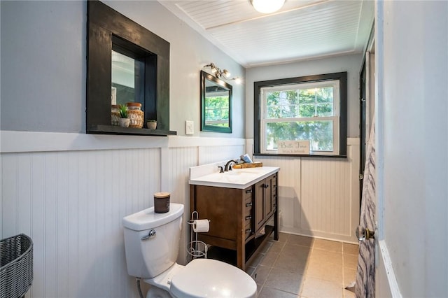 67 Pleasant St, Phelps, NY 14532 - bathroom with wainscoting, vanity, and tile patterned flooring