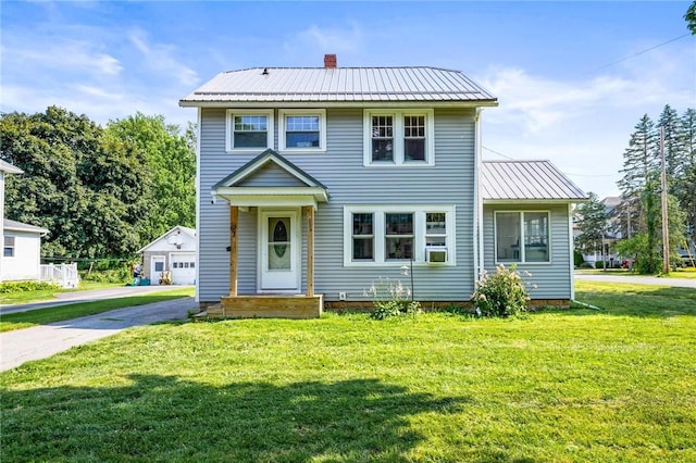 67 Pleasant St, Phelps, NY 14532 - view of front of property with a metal roof, a front yard, a garage, an outdoor structure, and a chimney