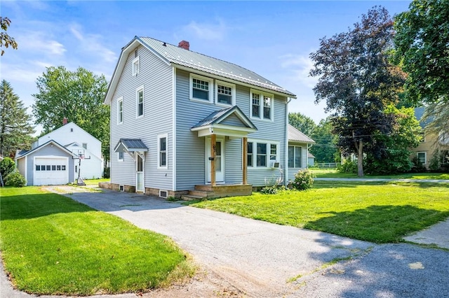 67 Pleasant St, Phelps, NY 14532 - view of front of house featuring a chimney, an outbuilding, asphalt driveway, and a front yard