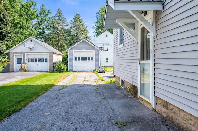 67 Pleasant St, Phelps, NY 14532 - view of side of home featuring a garage and an outdoor structure