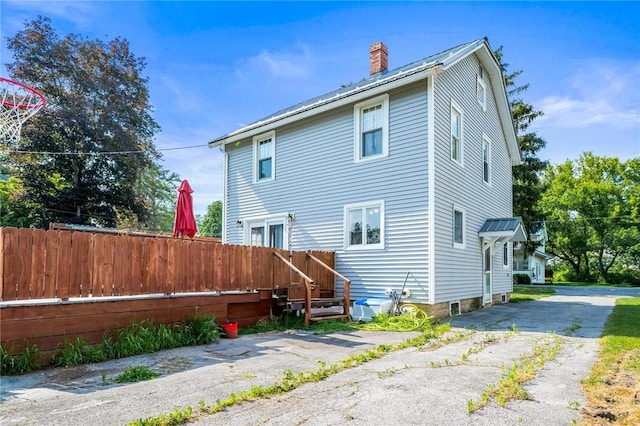 67 Pleasant St, Phelps, NY 14532 - rear view of property featuring a chimney