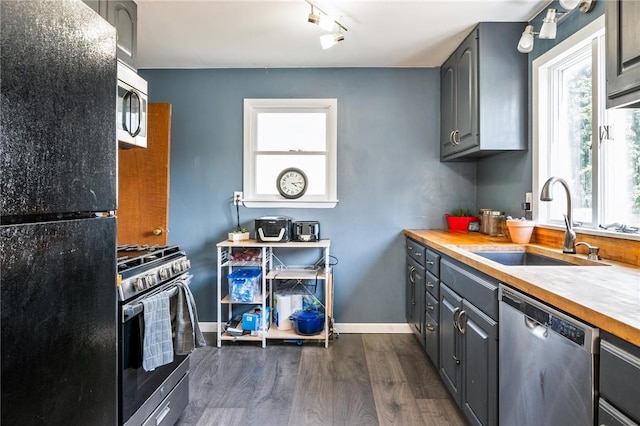 67 Pleasant St, Phelps, NY 14532 - kitchen featuring appliances with stainless steel finishes, dark wood-style flooring, gray cabinets, and healthy amount of natural light