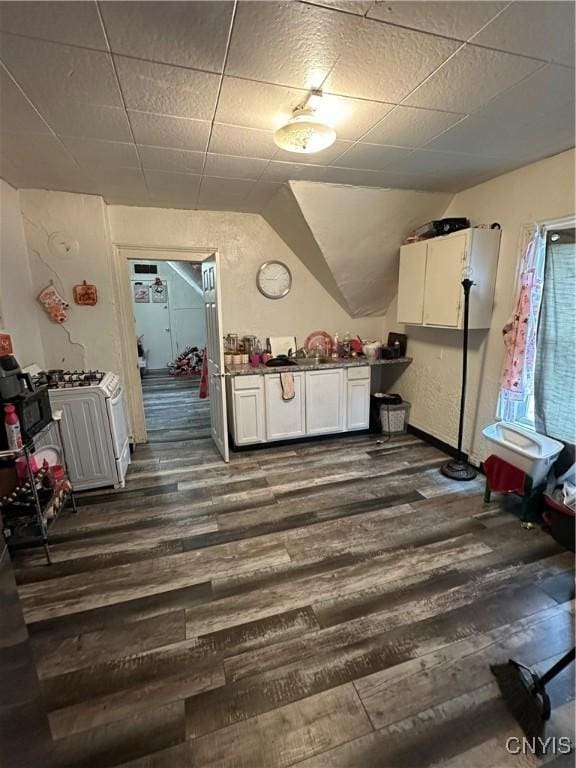 1417 Butternut St, Syracuse, NY 13208 - kitchen featuring dark wood-style floors, white cabinets, white gas stove, and vaulted ceiling