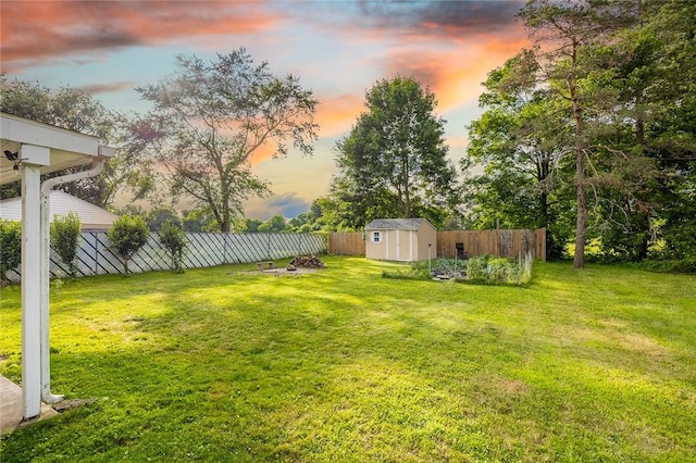 397 Merrill Pl, Southport, NY 14904 - yard at dusk featuring a storage unit and a fenced backyard